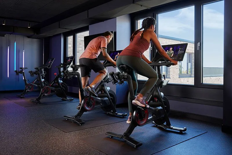 Small fitness studio with two people on stationary bikes