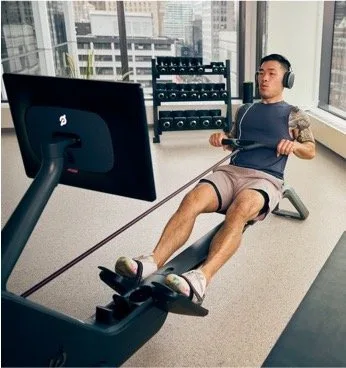 Peloton Rower with person working out