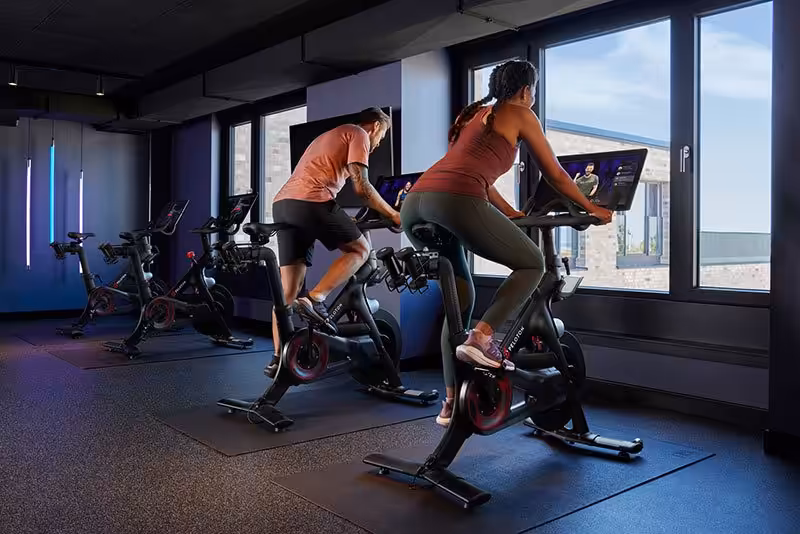 Small fitness studio with two people on stationary bikes