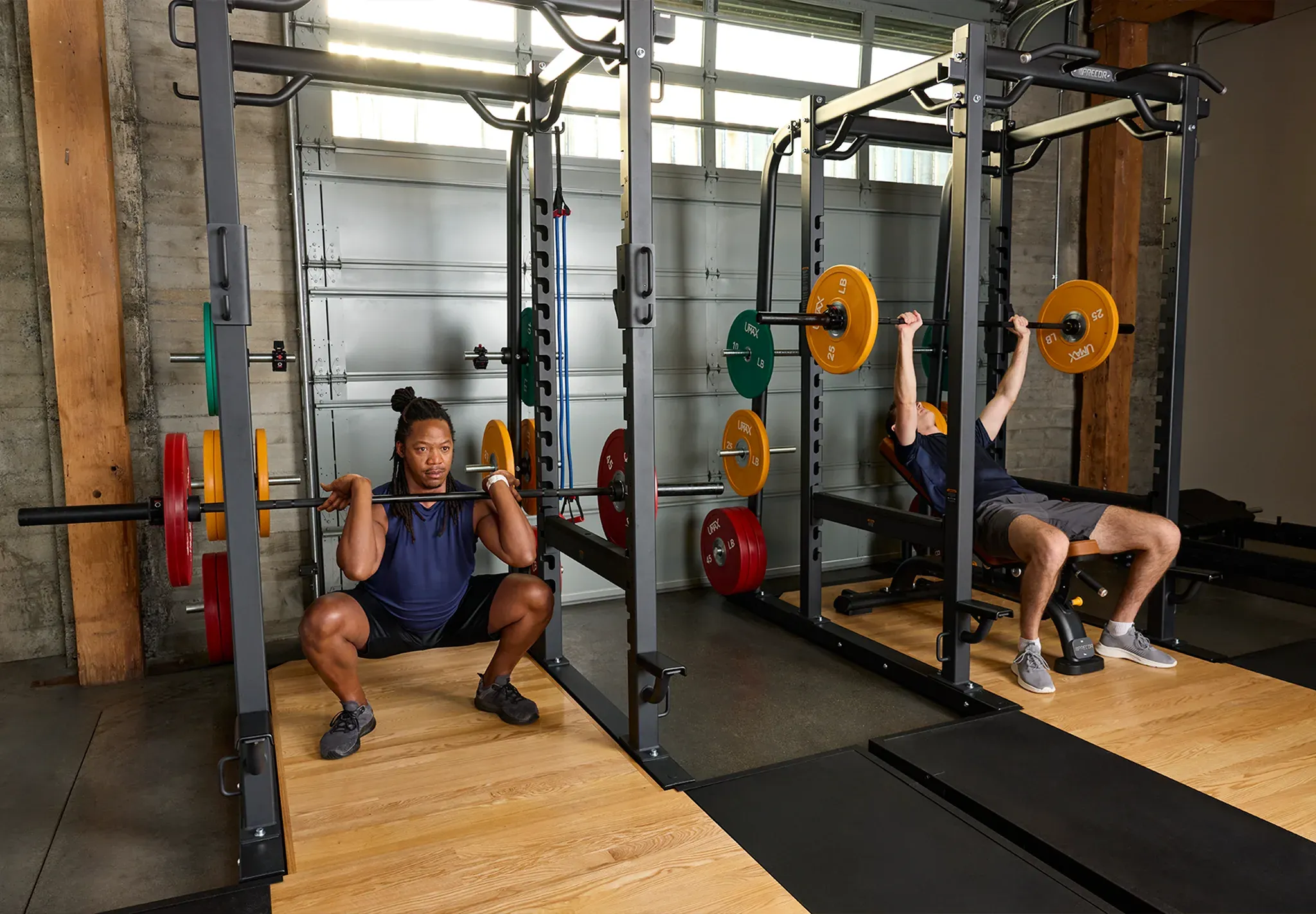 Precor bench and weight rack with people working out